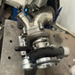 Turbocharger on a metal surface with tools in the background